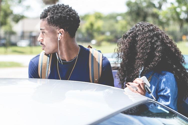 Young people at their car.