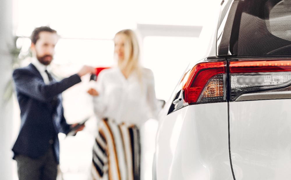 Young people at their car.